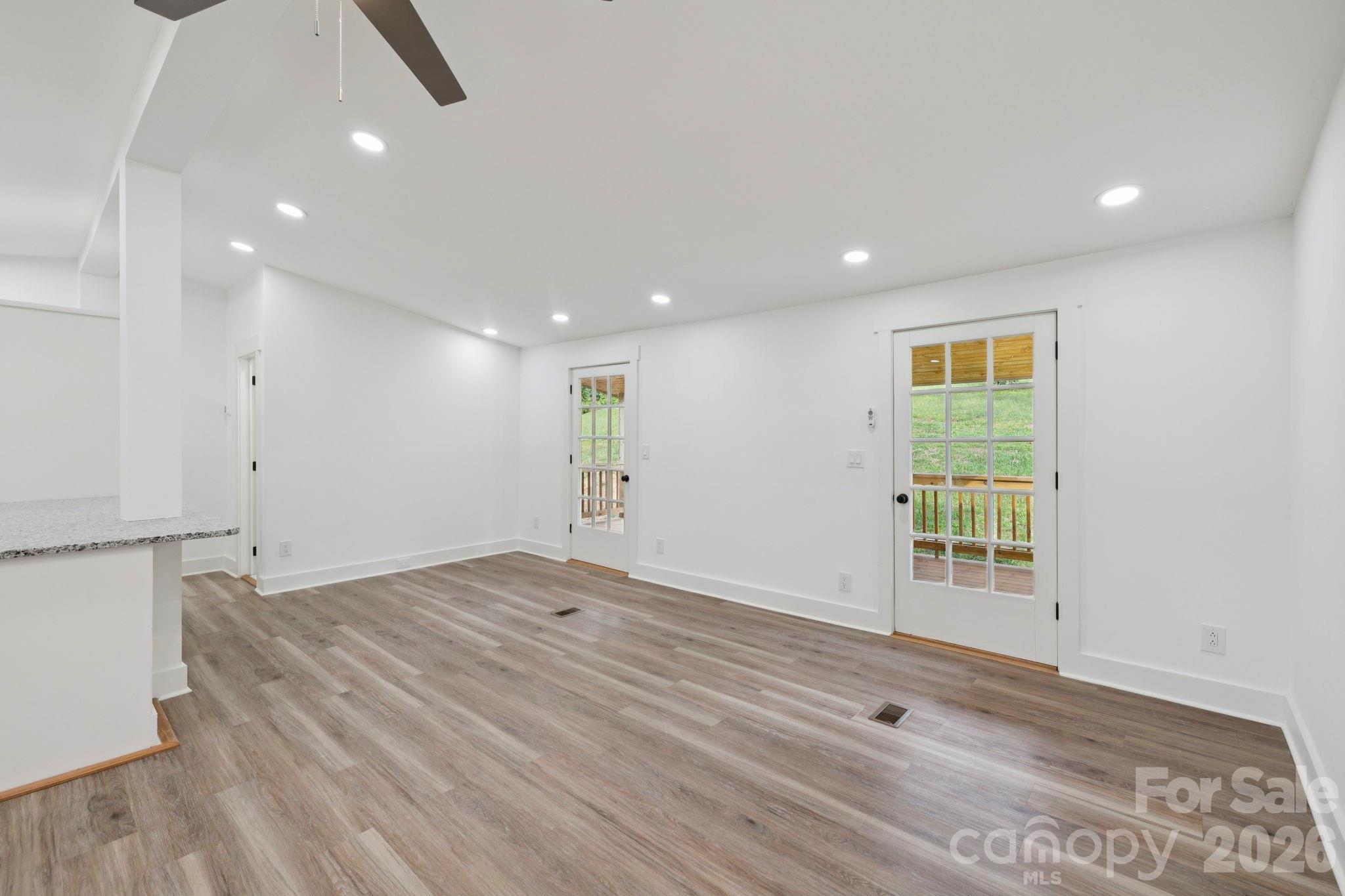431 Pole Miller Extension Brevard, NC 28712 - Photo 8 of 24 a view of an empty room with wooden floor and a window