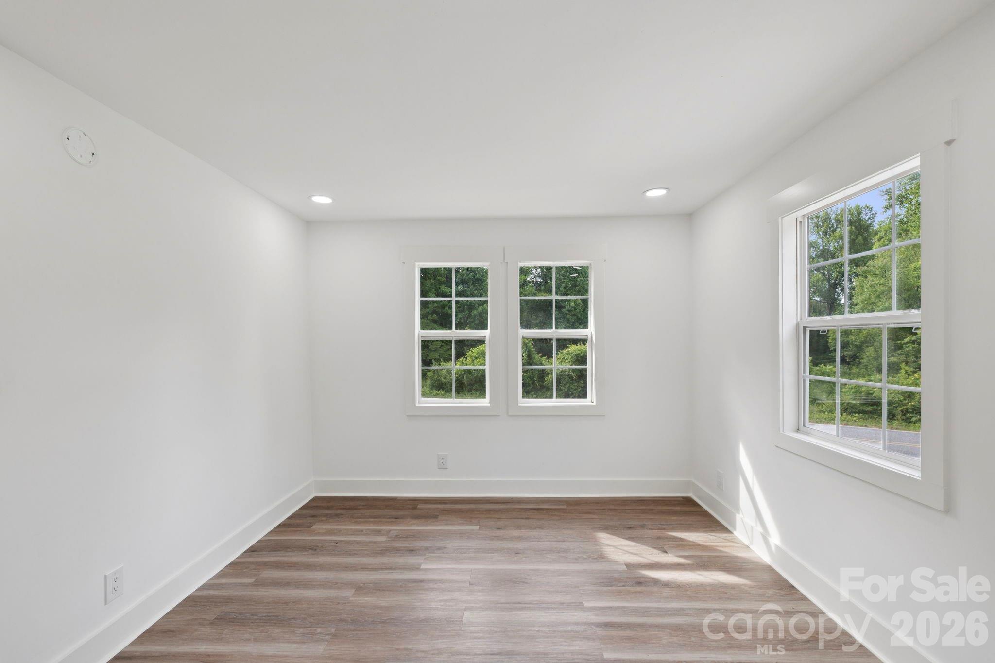 431 Pole Miller Extension Brevard, NC 28712 - Photo 9 of 24 an empty room with wooden floor and windows