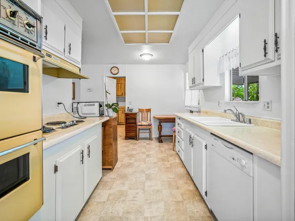 a kitchen with cabinets and window