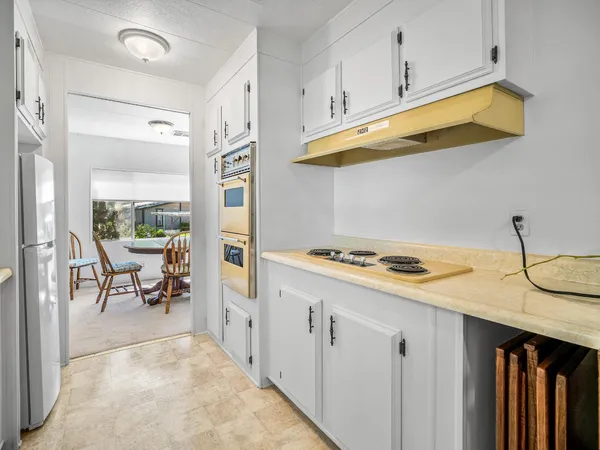 a kitchen with cabinets and window