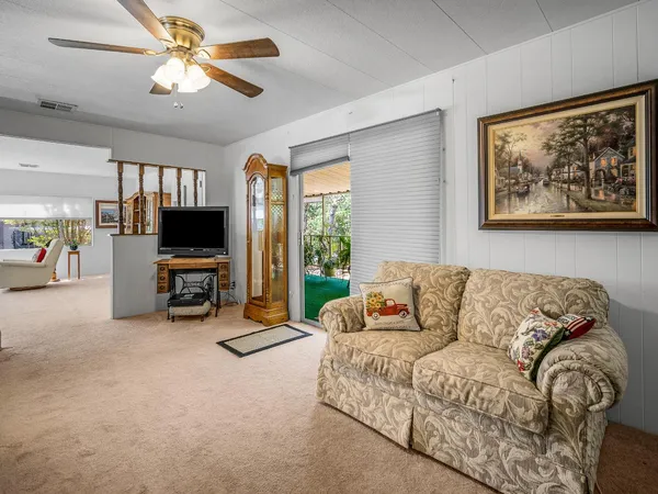 a living room with furniture and kitchen view
