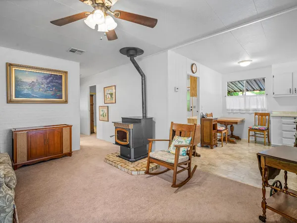 a dining room with furniture a chandelier and wooden floor