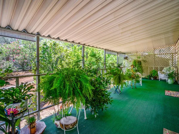 a room with lots of green space and a fountain
