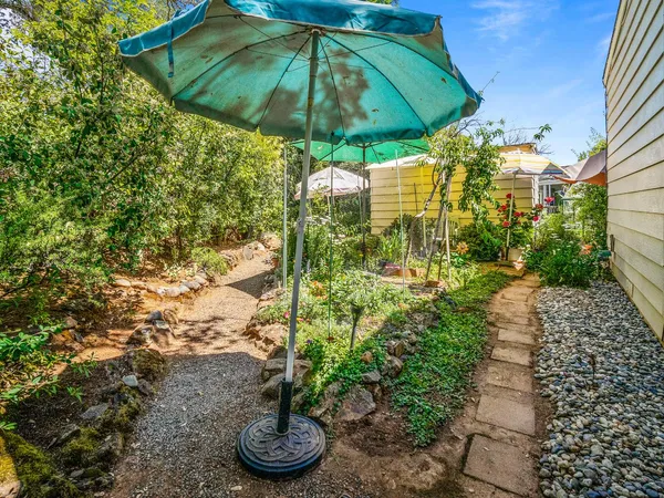 a view of a patio with table and chairs under an umbrella