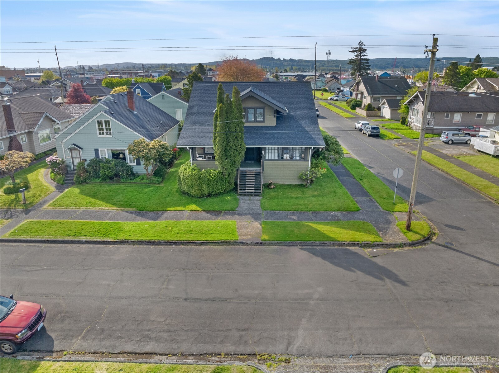 521 West 3rd Street Aberdeen, WA 98520 - Photo 1 of 13 a view of houses with a big yard and potted plants