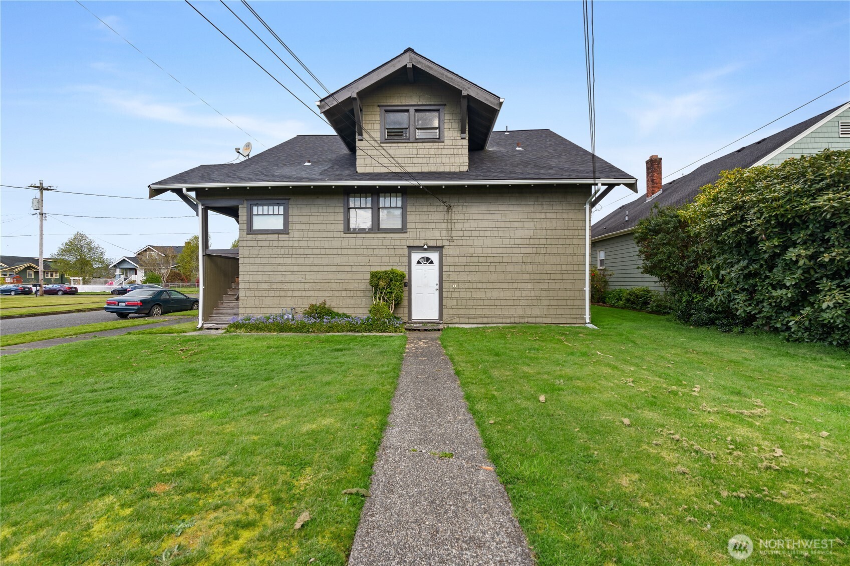 521 West 3rd Street Aberdeen, WA 98520 - Photo 7 of 13 a front view of a house with a yard and garage