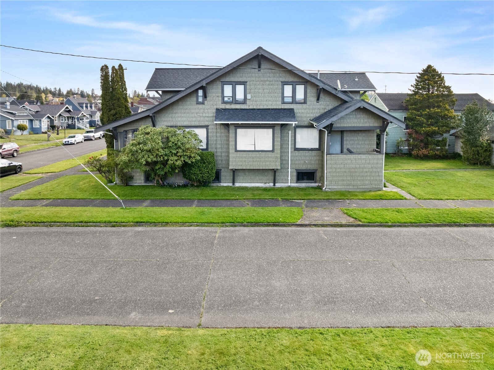 521 West 3rd Street Aberdeen, WA 98520 - Photo 9 of 13 a front view of a house with a yard and garage