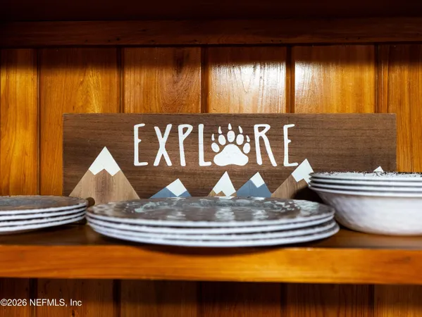 a view of a kitchen with stainless steel appliances granite countertop a sink and wooden cabinets