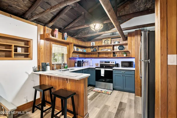 a kitchen with stainless steel appliances granite countertop a stove and a refrigerator