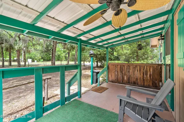 a view of a yard with plants and trees