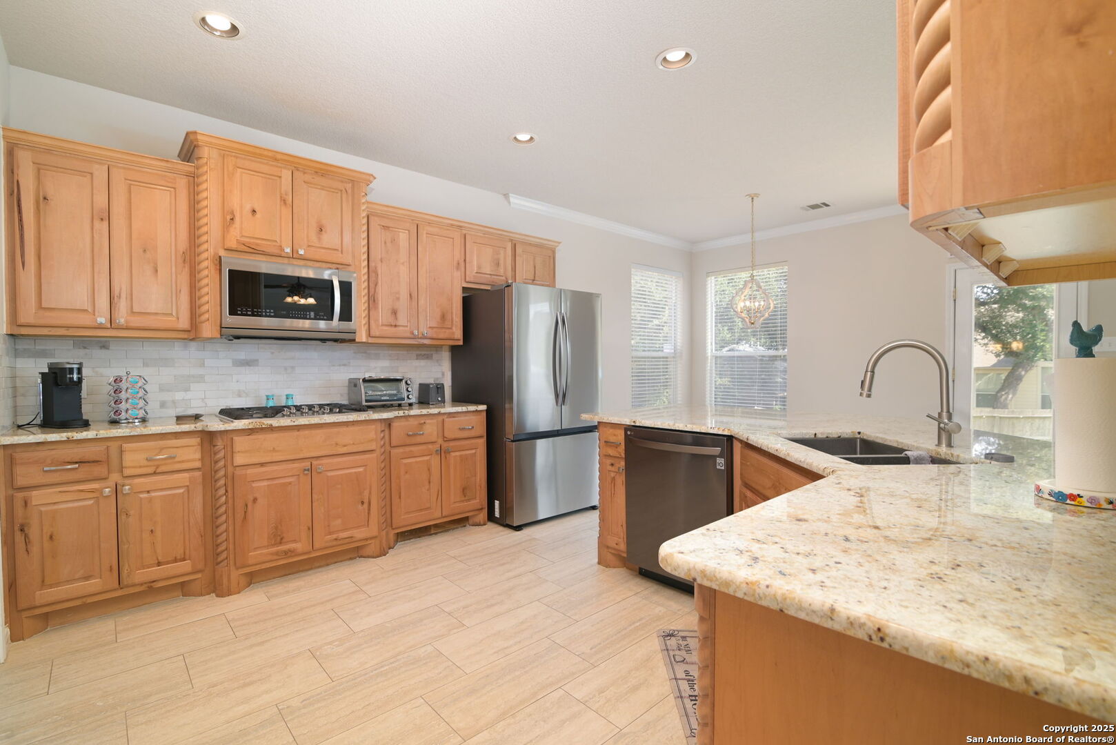8918 Cordes Junction Helotes, TX 78023 - Photo 12 of 41 a kitchen with stainless steel appliances granite countertop a sink stove and refrigerator