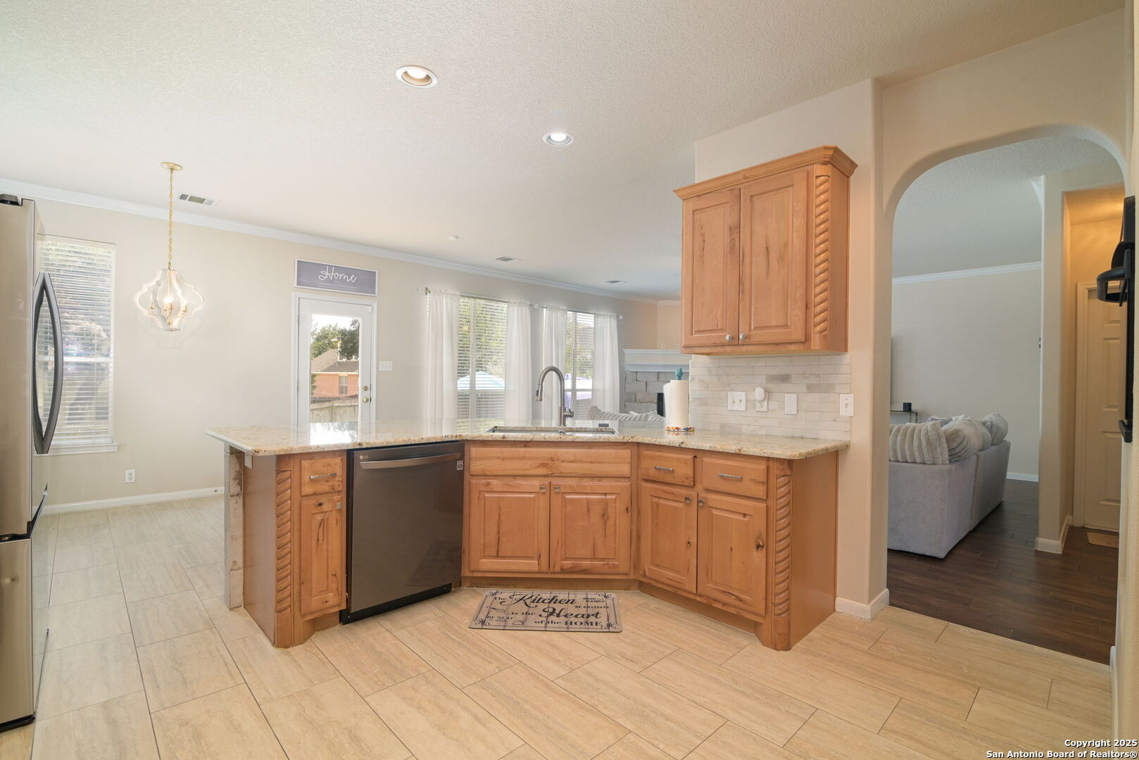 8918 Cordes Junction Helotes, TX 78023 - Photo 13 of 41 a large kitchen with granite countertop a sink and dishwasher stove top oven