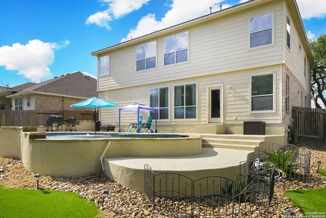 a view of a house with swimming pool and a chairs in patio