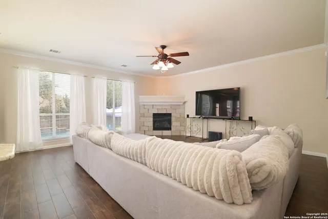 a living room with furniture fireplace and flat screen tv