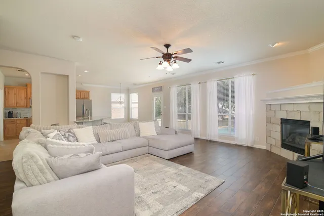 a living room with furniture a fireplace and a flat screen tv