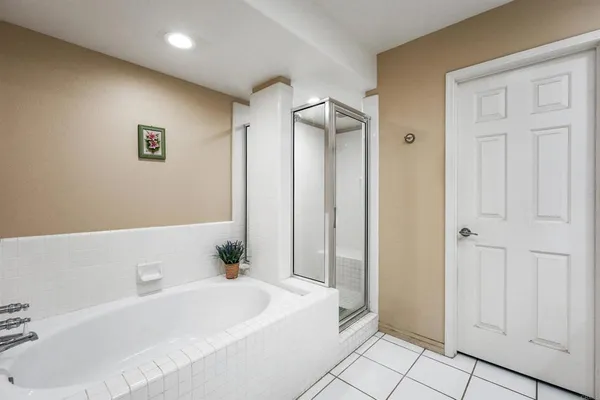 a bathroom with a bathtub and a shower