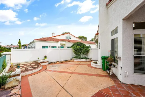 a view of a house with backyard and sitting area