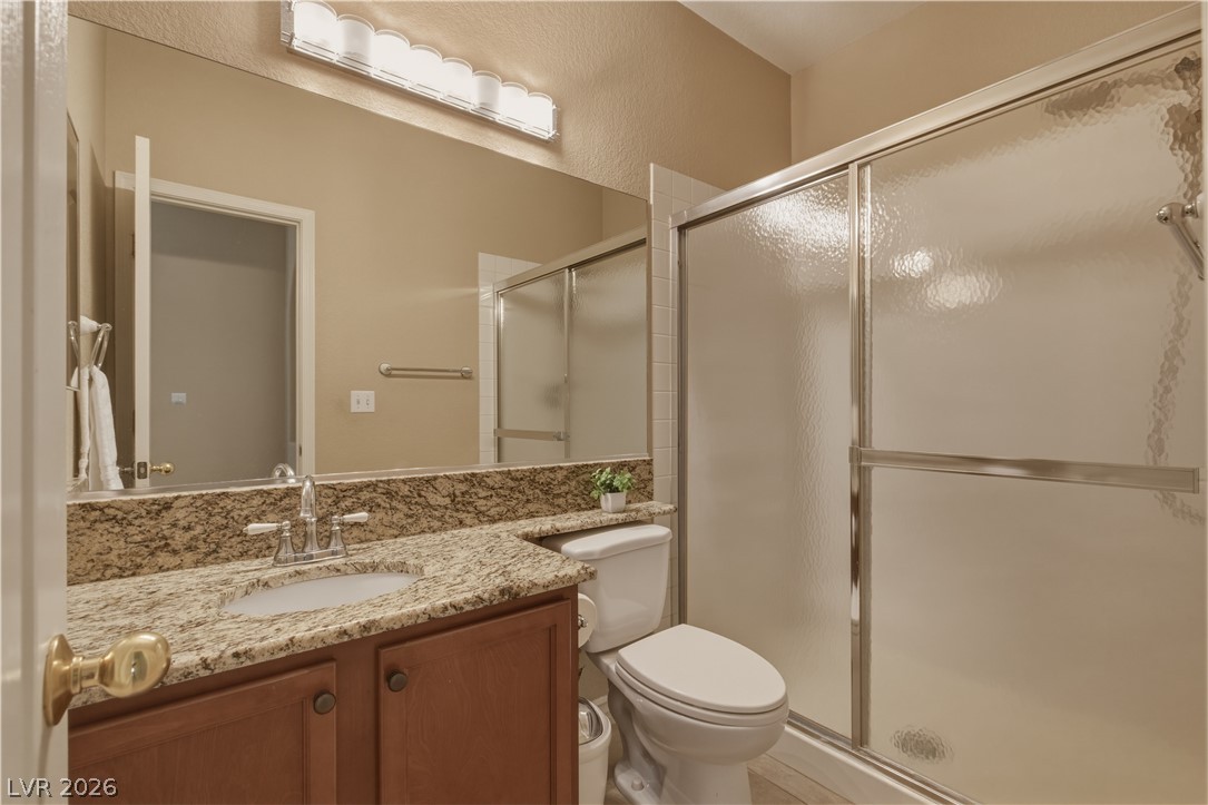 29 Olive Tree Henderson, NV 89074 - Photo 25 of 60 This bathroom features a sleek shower and a practical vanity with ample counter space.