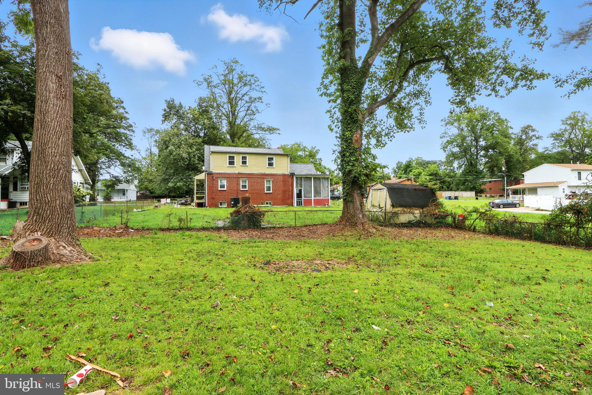 6603 Fairmount Avenue Baltimore, MD 21215 - Photo 16 of 19 a green field with trees in the background
