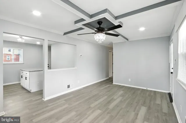 a view of an empty room and wooden floor