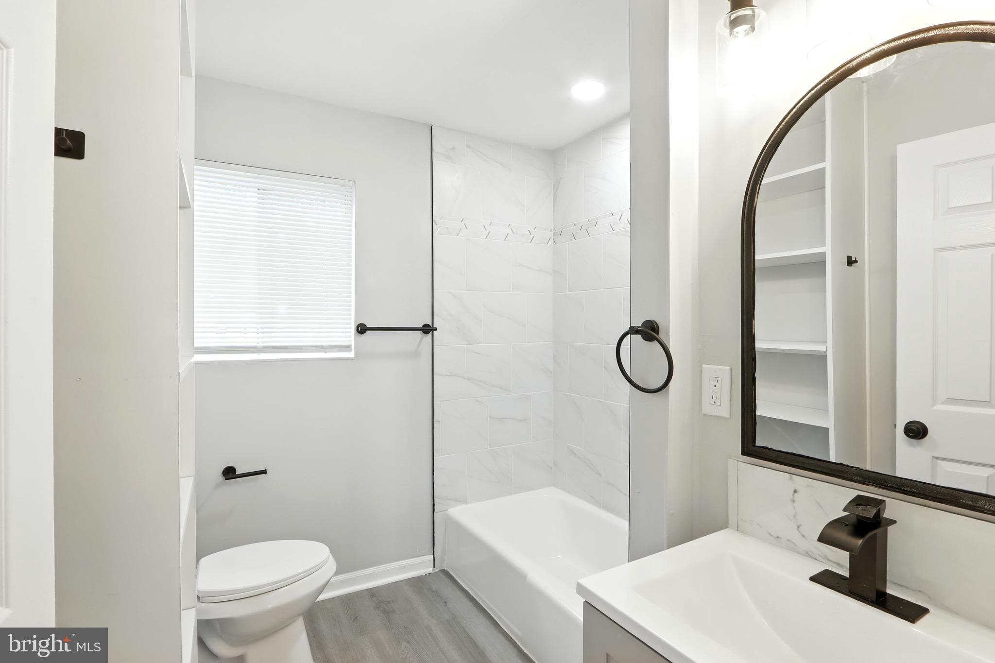 6603 Fairmount Avenue Baltimore, MD 21215 - Photo 8 of 19 a bathroom with a sink a toilet and shower