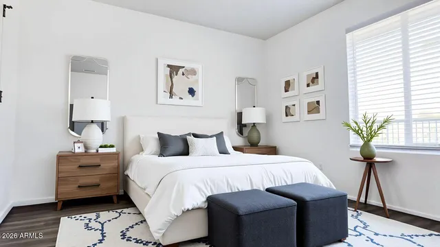 a bedroom with a bed and a potted plant