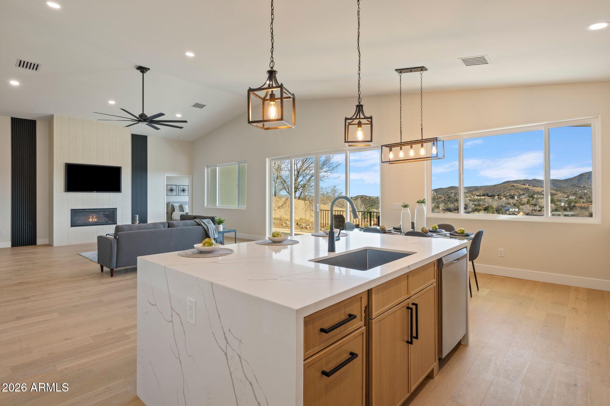 4535 Victor Drive Prescott, AZ 86301 - Photo 9 of 43 a kitchen with a stove a sink a window and chairs