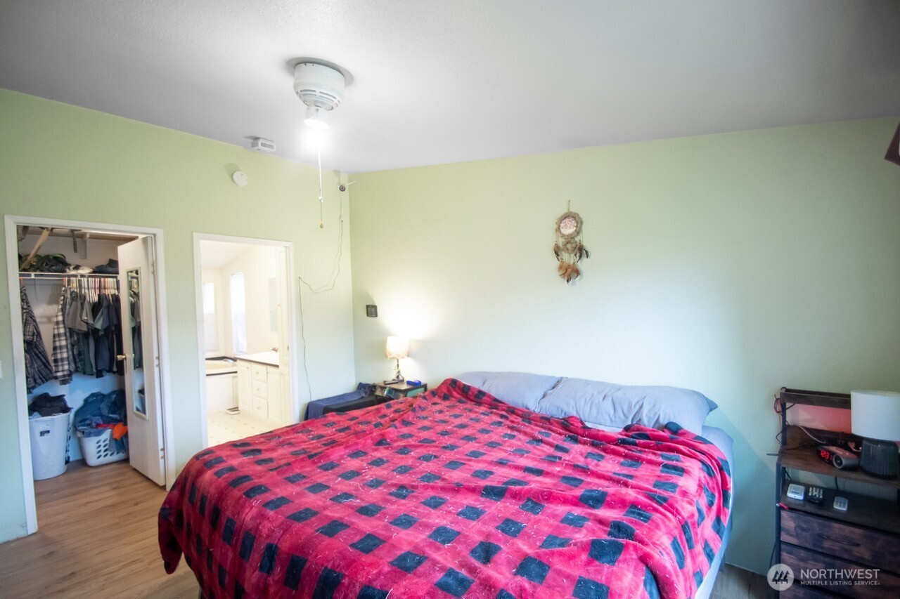 307 South 3rd Street Pe Ell, WA 98572 - Photo 11 of 29 a bedroom with a large bed and a chandelier