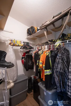 a view of walk in closet with clothes and shoes