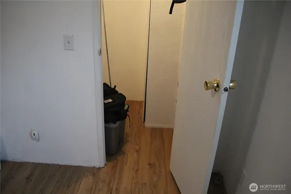 a view of a hallway with wooden floor
