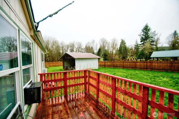 a balcony with tall trees in the background