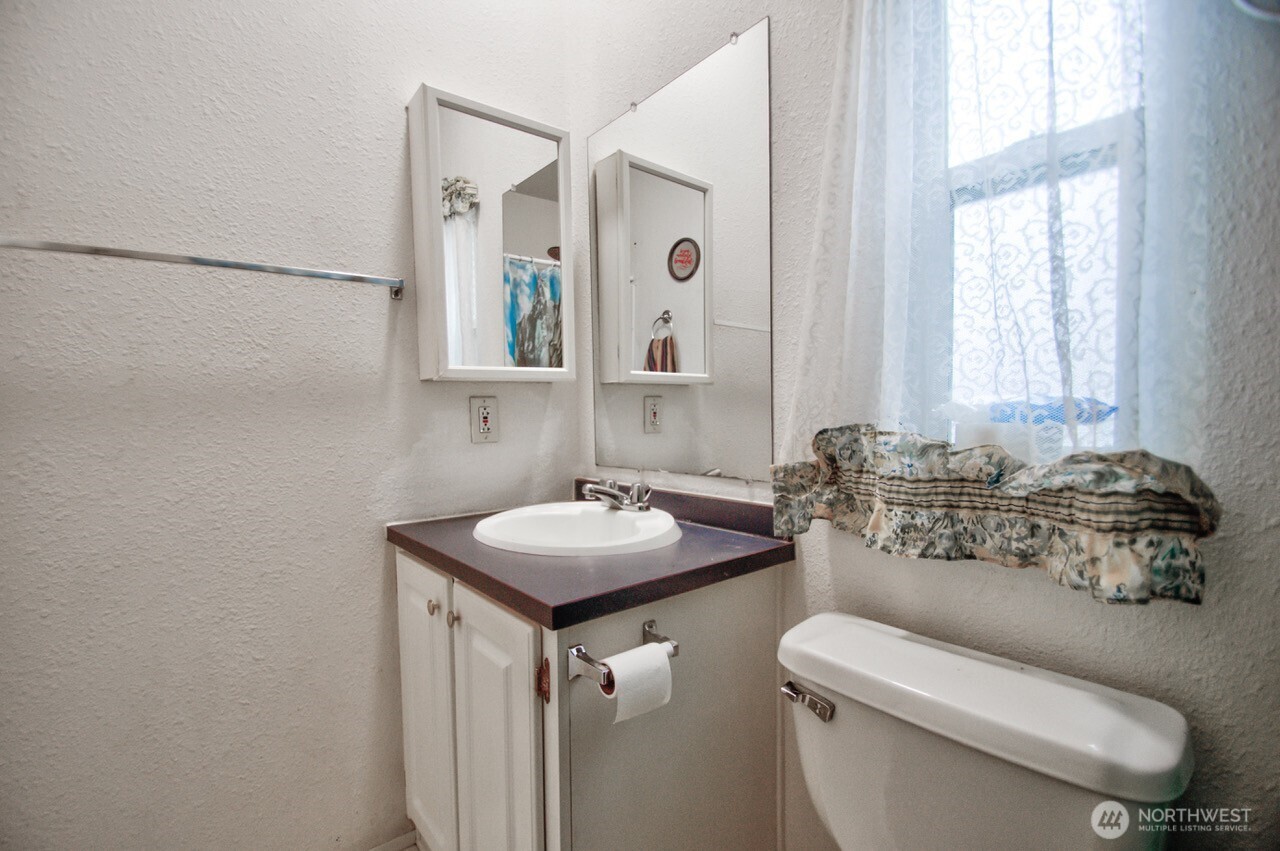 307 South 3rd Street Pe Ell, WA 98572 - Photo 21 of 29 a bathroom with a toilet sink and mirror