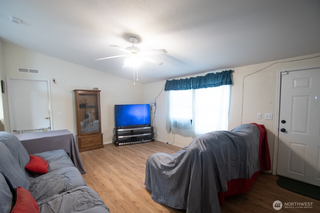 307 South 3rd Street Pe Ell, WA 98572 - Photo 7 of 29 a living room with furniture a window and a flat screen tv