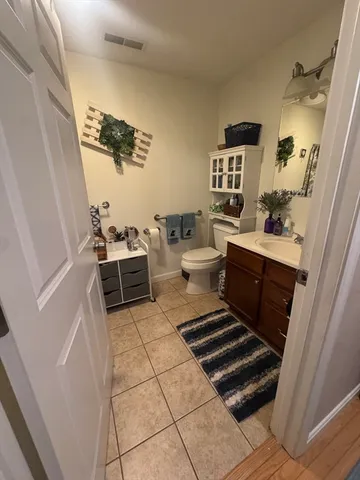 a room with a chair and white walls