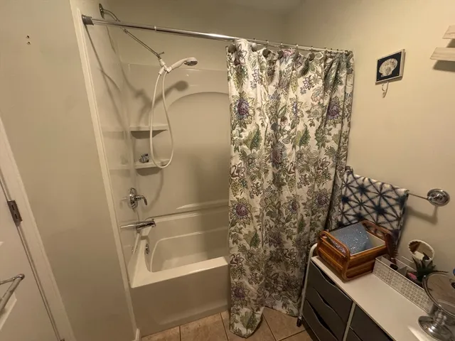 a bathroom with a shower curtain and a sink