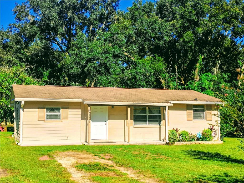18341 Geraldine Road Dade City, FL 33523 - Photo 1 of 1 a view of a house with a yard and sitting area