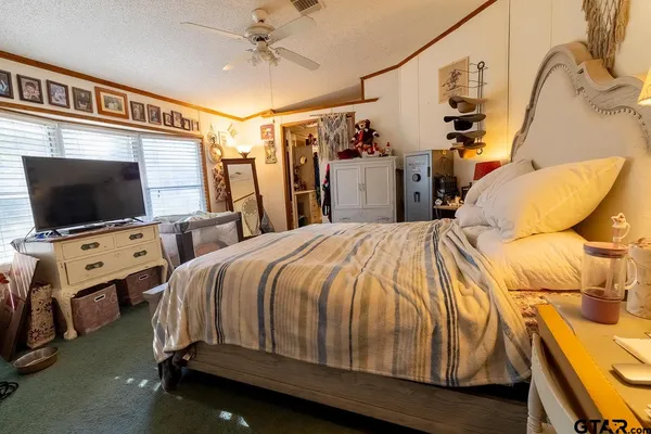 a bedroom with a bed and a flat screen tv
