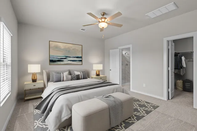 a bedroom with a large bed and a chandelier