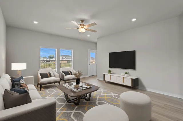a living room with furniture and a flat screen tv