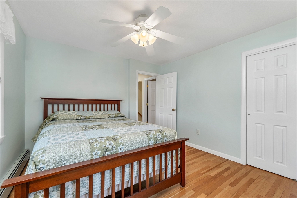 12 Emerson Road Nashua, NH 03062 - Photo 35 of 42 a bed sitting in a bedroom next to a bathroom