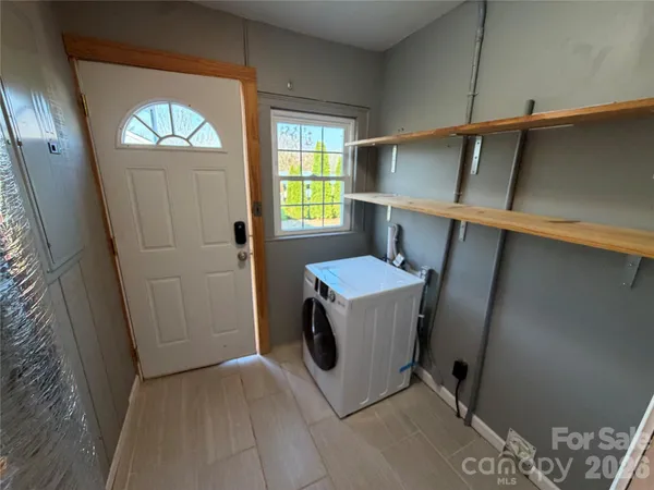 a utility room with closet dryer and washer