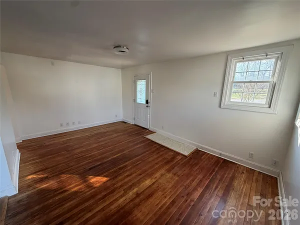 a view of small space with wooden floor and windows