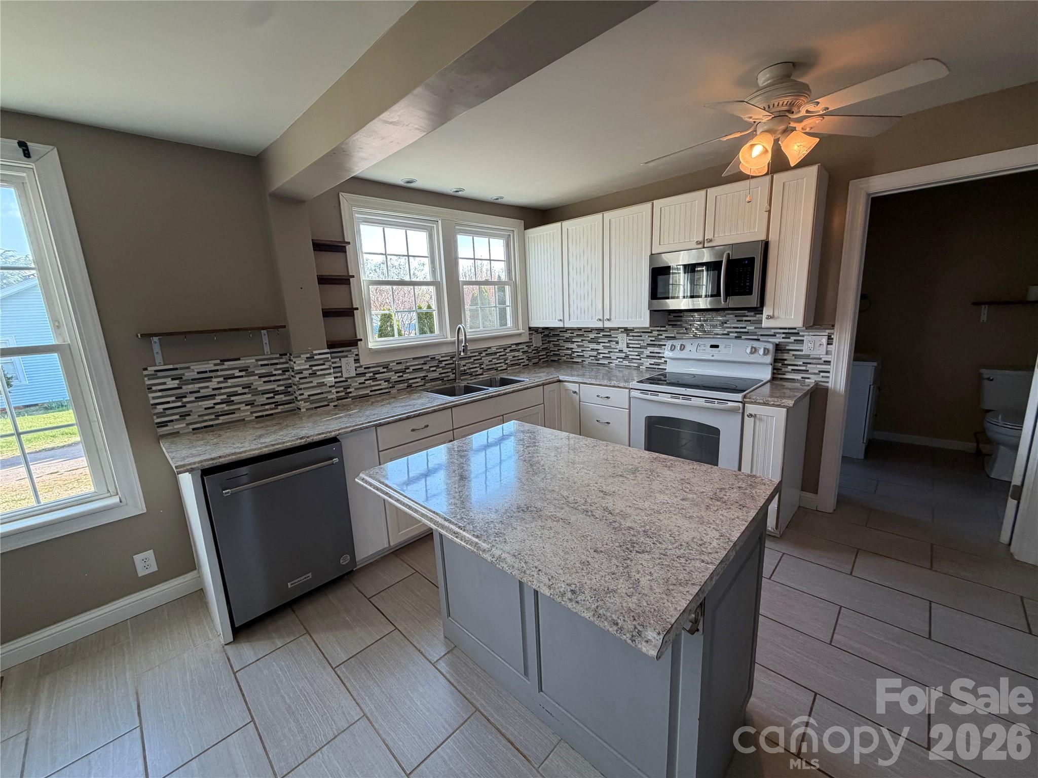 405 Jug Wilson Street Morganton, NC 28655 - Photo 4 of 21 a kitchen with stainless steel appliances granite countertop a sink stove and refrigerator