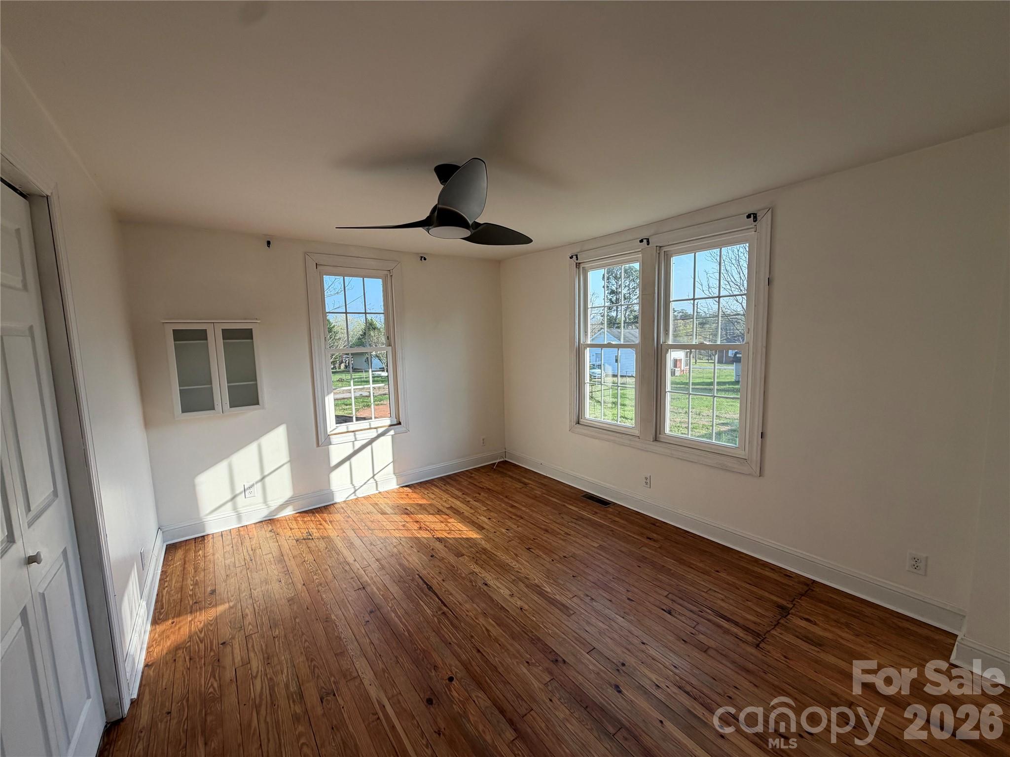 405 Jug Wilson Street Morganton, NC 28655 - Photo 8 of 21 a view of an empty room with a window and wooden floor