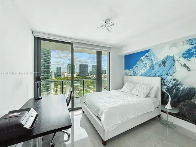 a bedroom with a bed and glass window