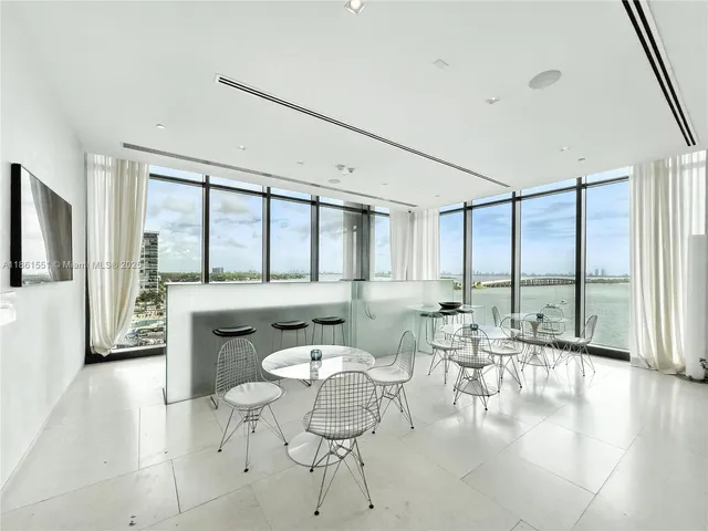 a living room with furniture large window and outer view