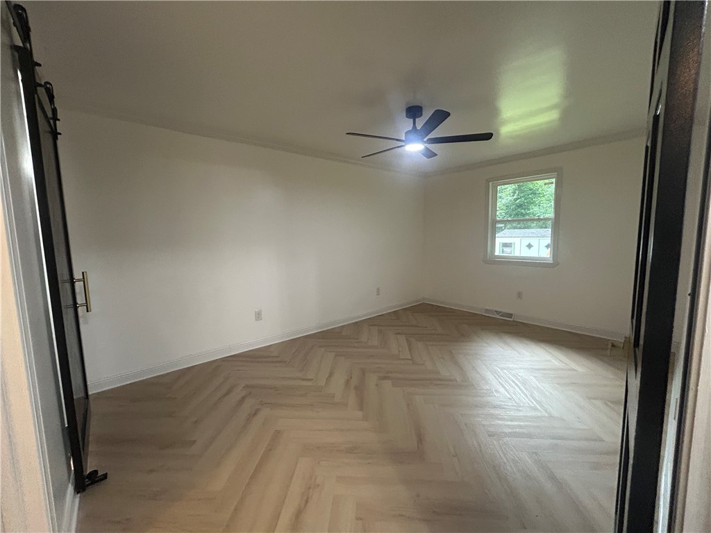 809 Paige Road Honea Path, SC 29654 - Photo 17 of 27 Herringbone pattern flooring extends across this naturally illuminated bedroom with a ceiling fan. MASTER