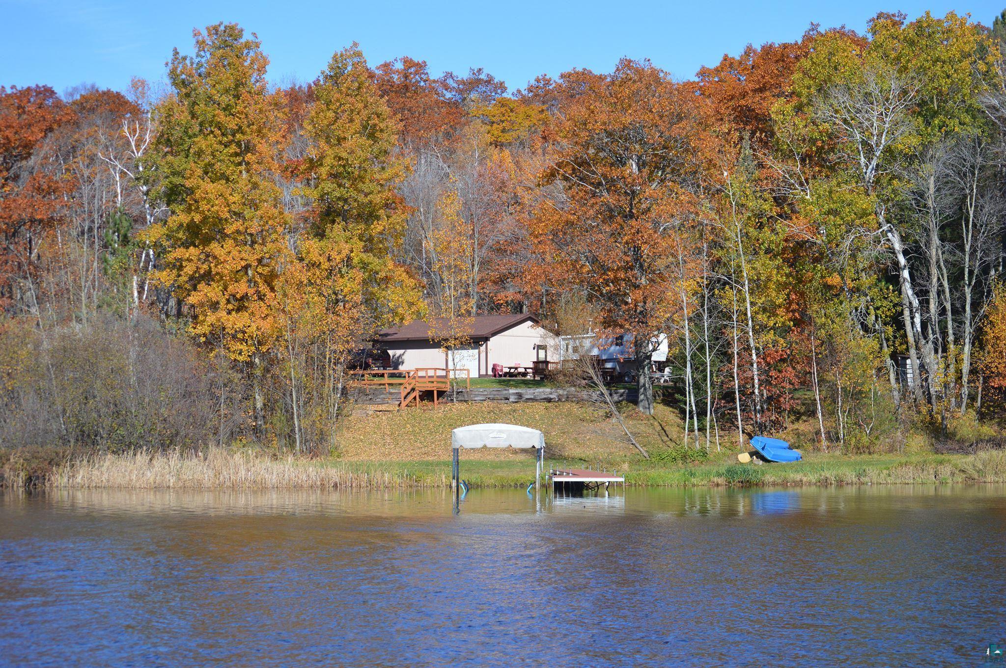 Waterfront property with a private dock featuring a boat lift