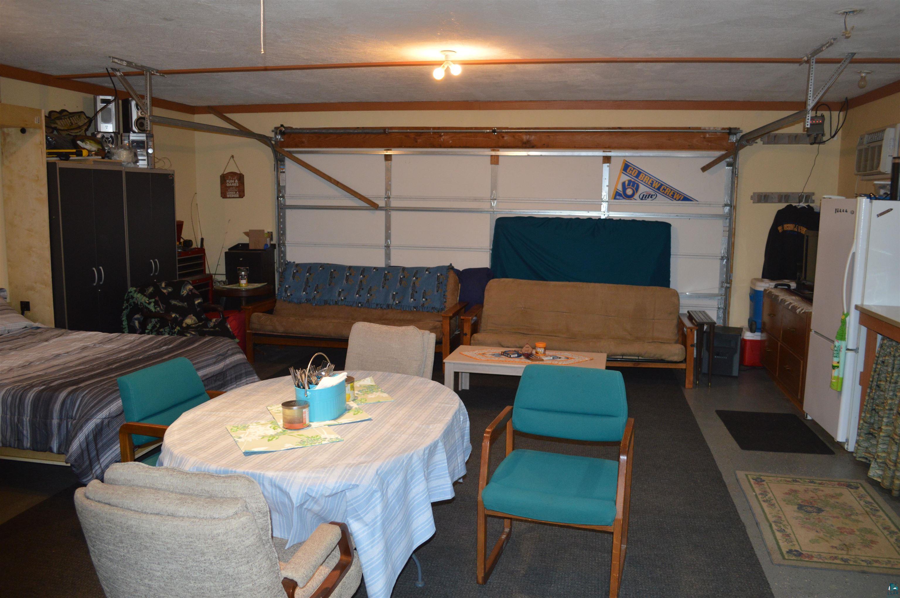 8467 County Rd P Lake Nebagamon, WI 54849 - Photo 12 of 25 Spacious garage interior with concrete flooring and exposed ceiling beams