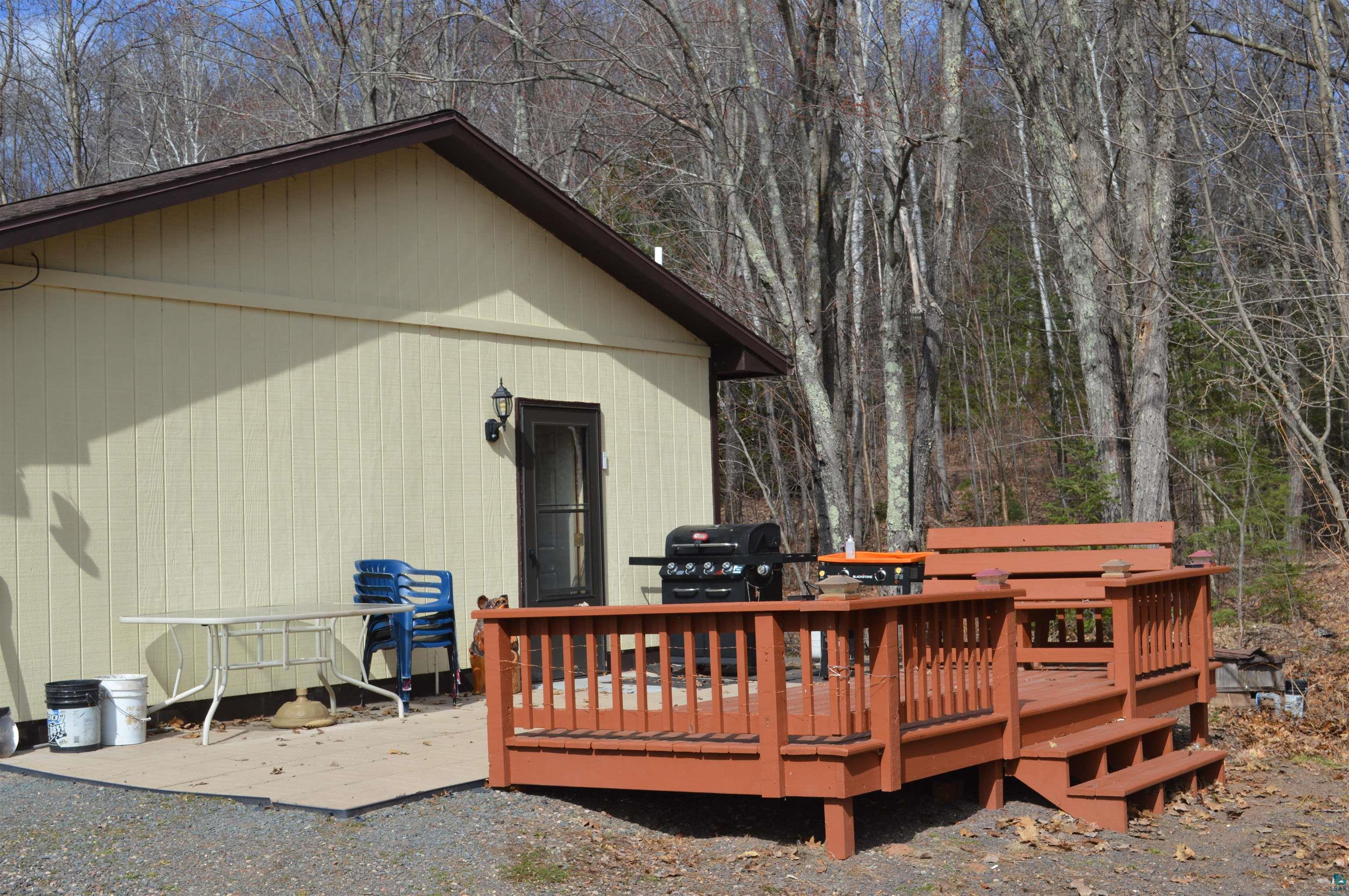 8467 County Rd P Lake Nebagamon, WI 54849 - Photo 14 of 25 Wood-toned deck with built-in bench seating and steps